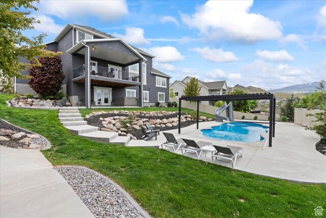 6688 W Buck Dr, Herriman, UT 84096 - view of pool with a water slide, french doors, a patio, a pergola, and a mountain view