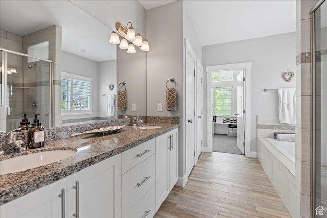 6688 W Buck Dr, Herriman, UT 84096 - bathroom featuring plenty of natural light, a shower stall, double vanity, and a garden tub