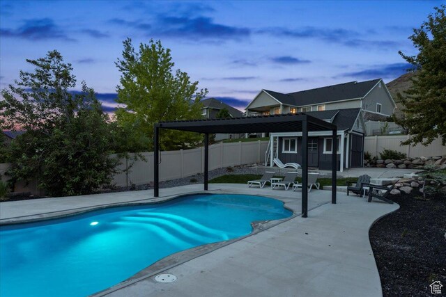 6688 W Buck Dr, Herriman, UT 84096 - pool at dusk with a fenced backyard, a patio, and an outbuilding