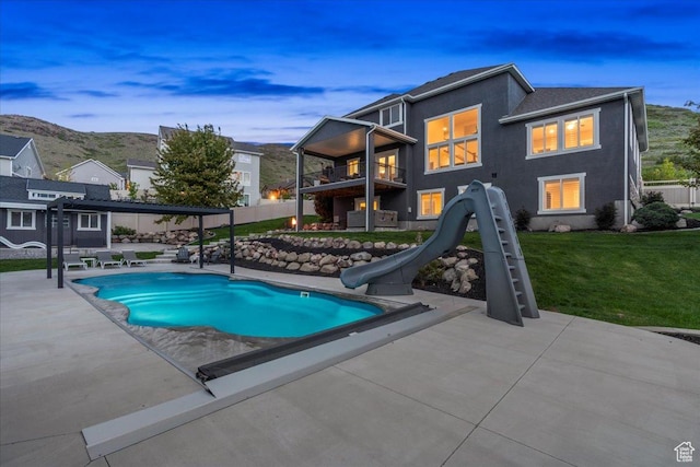 6688 W Buck Dr, Herriman, UT 84096 - view of pool featuring a water slide, a lawn, and a patio