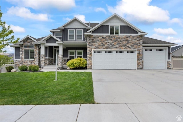 6688 W Buck Dr, Herriman, UT 84096 - craftsman-style home featuring stone siding, driveway, a front yard, board and batten siding, and covered porch