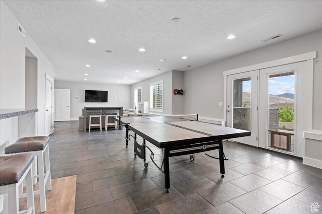 6688 W Buck Dr, Herriman, UT 84096 - rec room featuring recessed lighting, french doors, a textured ceiling, and baseboards