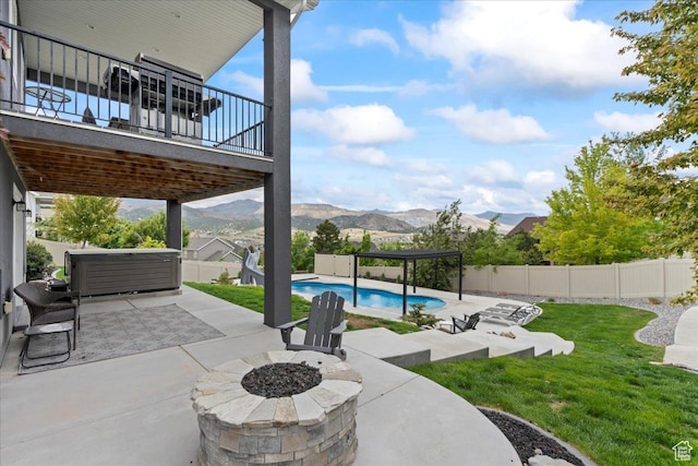6688 W Buck Dr, Herriman, UT 84096 - view of patio with an outdoor fire pit and a mountain view