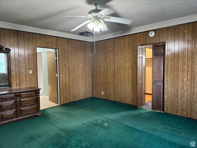 109 W 300 S, Holden, UT 84636 - unfurnished bedroom with carpet flooring, wooden walls, a textured ceiling, and a ceiling fan