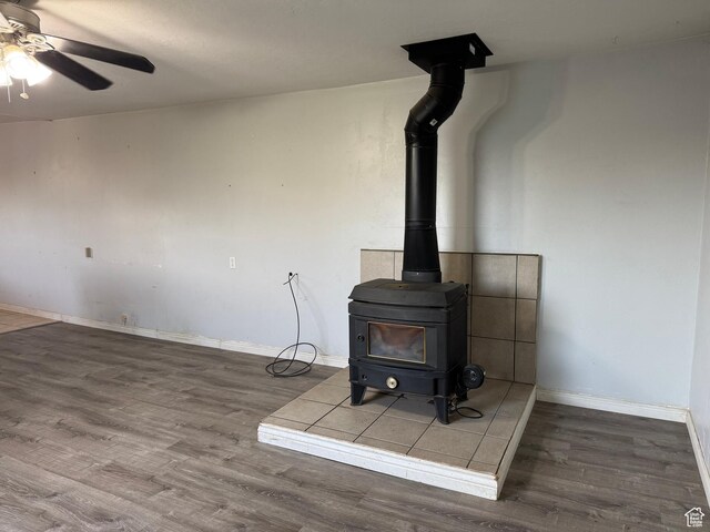 109 W 300 S, Holden, UT 84636 - detailed view of a wood stove, wood finished floors, a ceiling fan, and baseboards