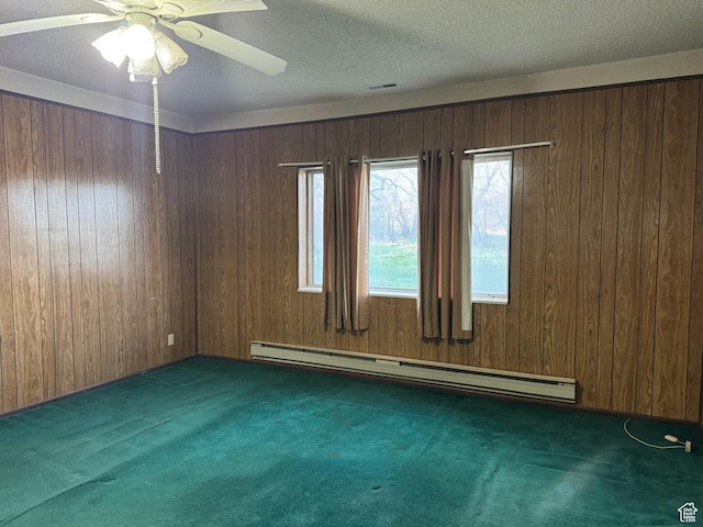 109 W 300 S, Holden, UT 84636 - spare room featuring baseboard heating, carpet, wooden walls, a ceiling fan, and a textured ceiling