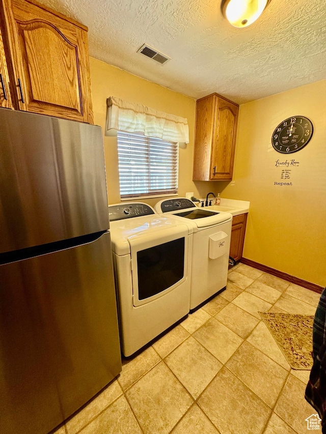 1660 E 900 S Unit 19, Clearfield, UT 84015 - laundry room featuring a textured ceiling, washer and dryer, light tile patterned flooring, a sink, and baseboards