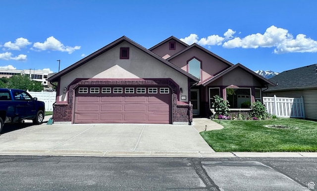 1660 E 900 S Unit 19, Clearfield, UT 84015 - view of front of home with stucco siding, an attached garage, driveway, and brick siding