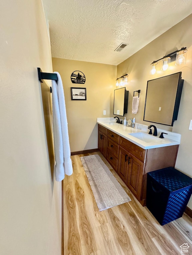 1660 E 900 S Unit 19, Clearfield, UT 84015 - full bathroom featuring wood finished floors, a textured ceiling, double vanity, and baseboards