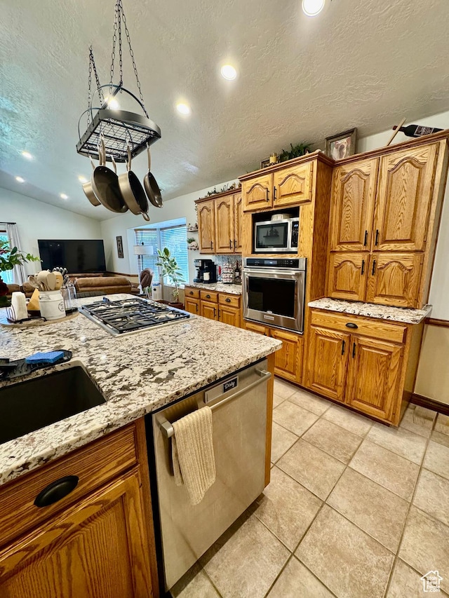 1660 E 900 S Unit 19, Clearfield, UT 84015 - kitchen with appliances with stainless steel finishes, a textured ceiling, light stone counters, brown cabinetry, and recessed lighting