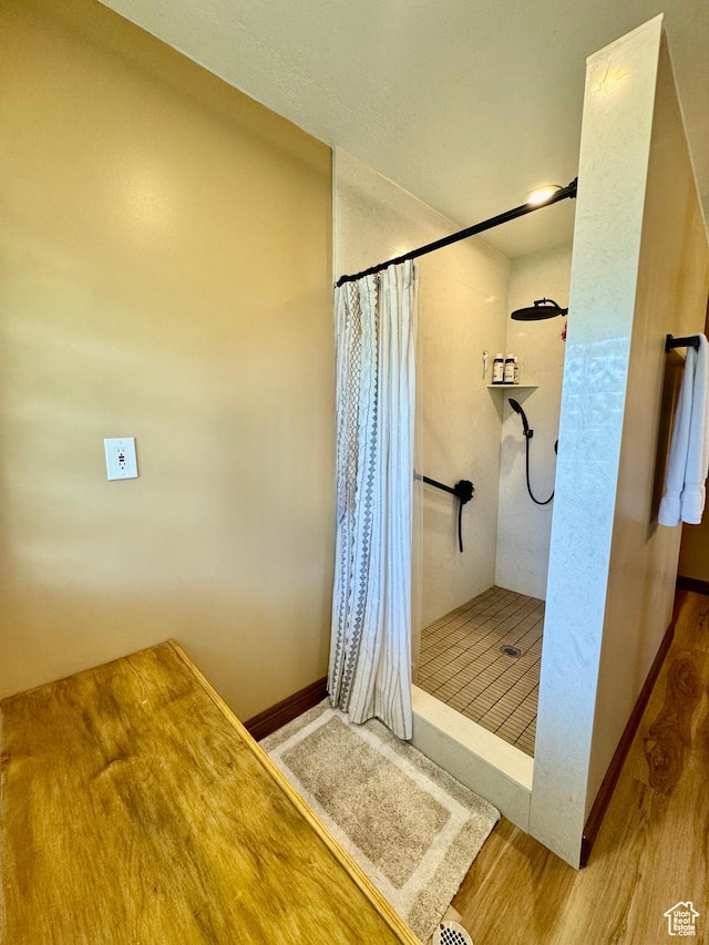 1660 E 900 S Unit 19, Clearfield, UT 84015 - bathroom featuring a shower stall, wood finished floors, and baseboards
