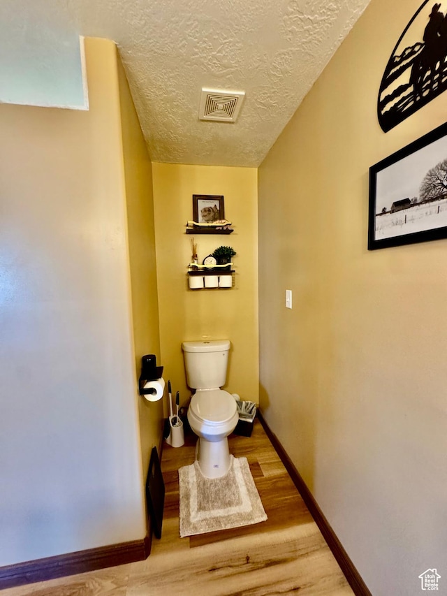 1660 E 900 S Unit 19, Clearfield, UT 84015 - bathroom featuring toilet, wood finished floors, a textured ceiling, and baseboards