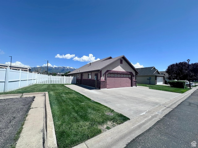 1660 E 900 S Unit 19, Clearfield, UT 84015 - view of yard featuring an attached garage, concrete driveway, and a mountain view