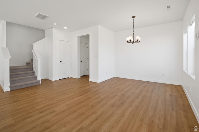 4945 W Willowbank Dr W, Highland, UT 84003 - empty room featuring a chandelier, light wood-style floors, baseboards, stairway, and recessed lighting