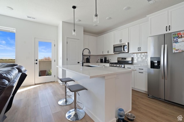 4945 W Willowbank Dr W, Highland, UT 84003 - kitchen with appliances with stainless steel finishes, a sink, light wood-style flooring, and healthy amount of natural light