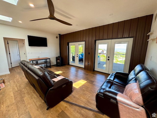 357 Juniper Dr Unit 480, Fish Haven, ID 83287 - living area with french doors, healthy amount of natural light, a ceiling fan, light wood-style flooring, and wood walls