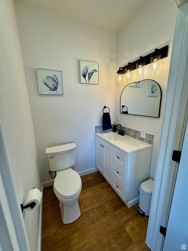 357 Juniper Dr Unit 480, Fish Haven, ID 83287 - bathroom featuring toilet, wood finished floors, vanity, and baseboards