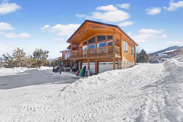 14434 N 11550 E, Mount Pleasant, UT 84647 - snow covered house featuring stairway, a garage, and stone siding