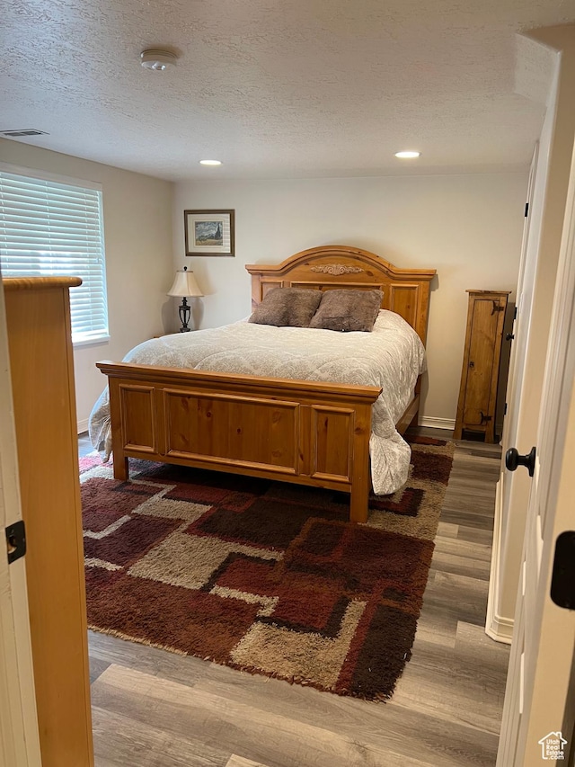 93 E Sweet Berry Ct, Draper, UT 84020 - bedroom with dark wood-style floors, a textured ceiling, and recessed lighting