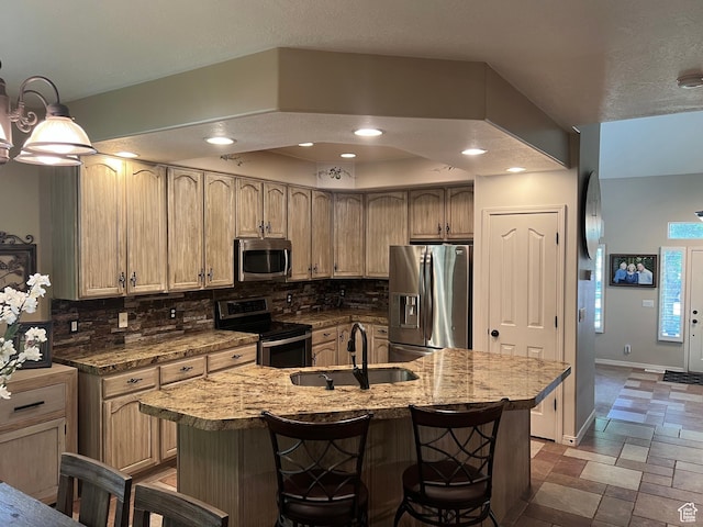 93 E Sweet Berry Ct, Draper, UT 84020 - kitchen featuring stainless steel appliances, a sink, tasteful backsplash, stone tile floors, and a kitchen bar