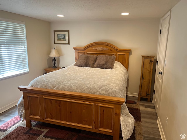 93 E Sweet Berry Ct, Draper, UT 84020 - bedroom featuring dark wood-type flooring, multiple windows, baseboards, recessed lighting, and a textured ceiling