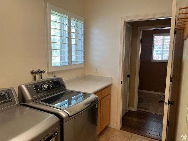 93 E Sweet Berry Ct, Draper, UT 84020 - laundry area with independent washer and dryer, cabinet space, healthy amount of natural light, and light tile patterned floors