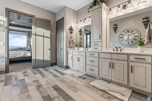 15113 S Cedar Meadow Cir, Herriman, UT 84096 - ensuite bathroom featuring double vanity, wood finished floors, and plenty of natural light