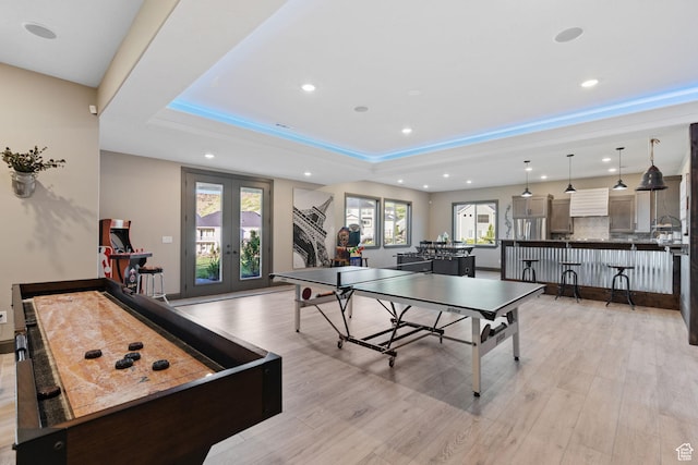 15113 S Cedar Meadow Cir, Herriman, UT 84096 - game room featuring french doors, recessed lighting, light wood-style floors, healthy amount of natural light, and a tray ceiling