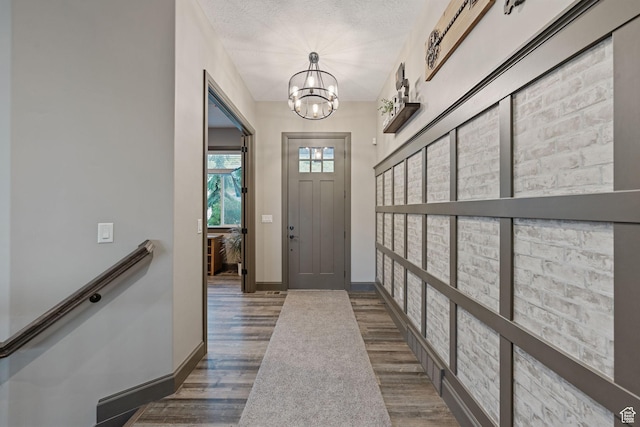 15113 S Cedar Meadow Cir, Herriman, UT 84096 - foyer entrance with wood finished floors, a chandelier, and baseboards