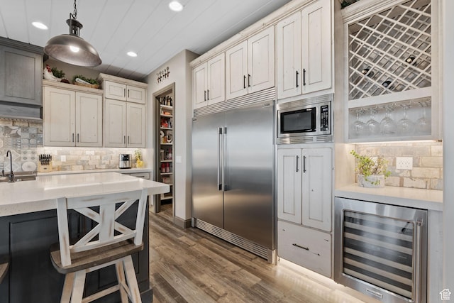 15113 S Cedar Meadow Cir, Herriman, UT 84096 - kitchen with built in appliances, wine cooler, recessed lighting, tasteful backsplash, and a sink