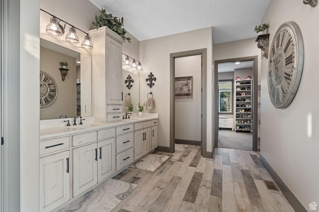 15113 S Cedar Meadow Cir, Herriman, UT 84096 - bathroom with double vanity, baseboards, wood finished floors, and a spacious closet