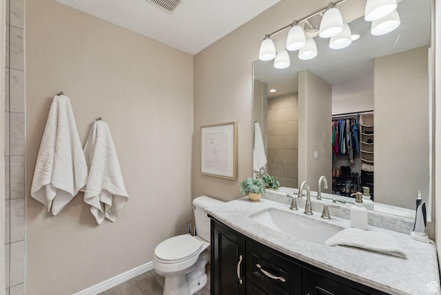 926 N 600 W, American Fork, UT 84003 - bathroom with vanity, toilet, a spacious closet, baseboards, and wood finished floors