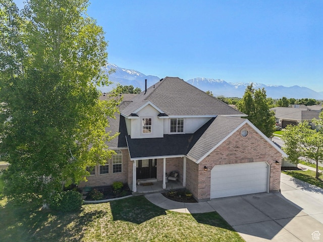 926 N 600 W, American Fork, UT 84003 - traditional-style house with a mountain view, brick siding, an attached garage, concrete driveway, and a porch