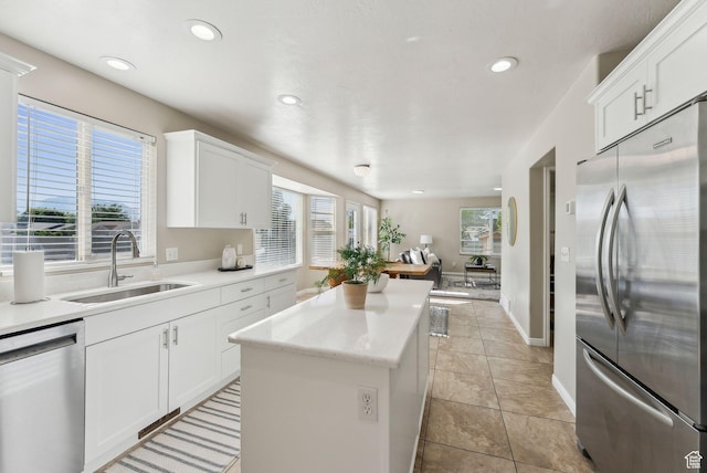926 N 600 W, American Fork, UT 84003 - kitchen featuring stainless steel appliances, a sink, a center island, recessed lighting, and white cabinetry
