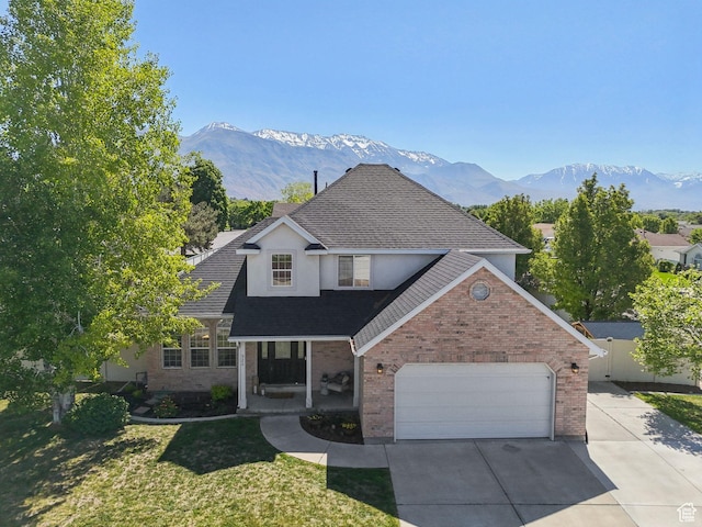 926 N 600 W, American Fork, UT 84003 - traditional-style house featuring brick siding, a porch, concrete driveway, and a mountain view