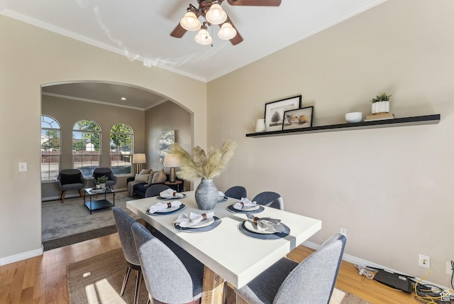 926 N 600 W, American Fork, UT 84003 - dining space with arched walkways, wood finished floors, a ceiling fan, ornamental molding, and baseboards
