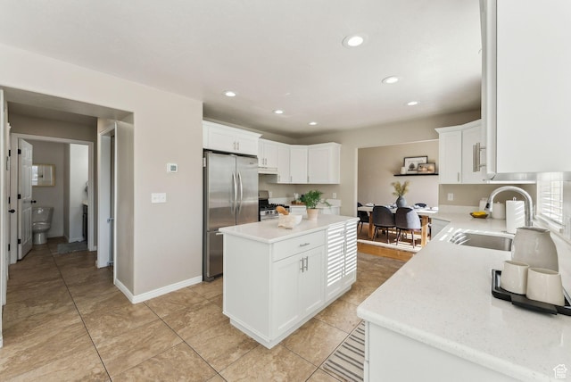 926 N 600 W, American Fork, UT 84003 - kitchen featuring appliances with stainless steel finishes, a sink, a center island, recessed lighting, and white cabinets