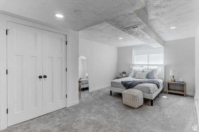 7474 S Brighton Way, Cottonwood Heights, UT 84121 - bedroom with carpet, baseboards, arched walkways, a closet, and a textured ceiling