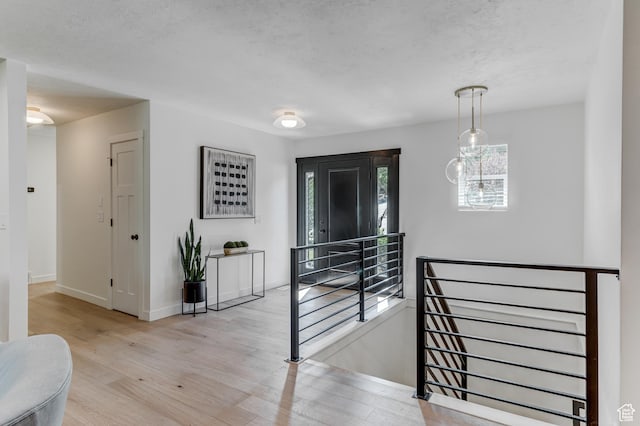 7474 S Brighton Way, Cottonwood Heights, UT 84121 - hallway featuring an upstairs landing, wood finished floors, baseboards, and a textured ceiling
