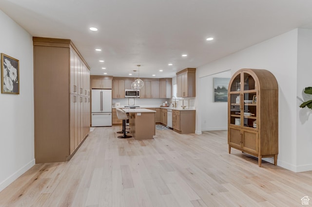 7474 S Brighton Way, Cottonwood Heights, UT 84121 - kitchen with white appliances, a breakfast bar area, light countertops, a center island, and recessed lighting
