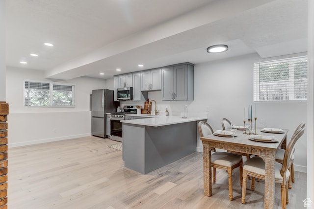 7474 S Brighton Way, Cottonwood Heights, UT 84121 - kitchen with stainless steel appliances, baseboards, light wood finished floors, light countertops, and gray cabinetry