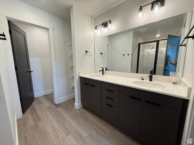 3664 S 4600 W Unit 222, West Haven, UT 84401 - full bath featuring wood finished floors, double vanity, a stall shower, and baseboards