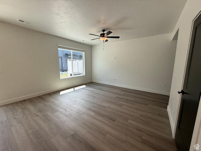 3664 S 4600 W Unit 222, West Haven, UT 84401 - spare room featuring a textured ceiling, a ceiling fan, dark wood-style flooring, and baseboards