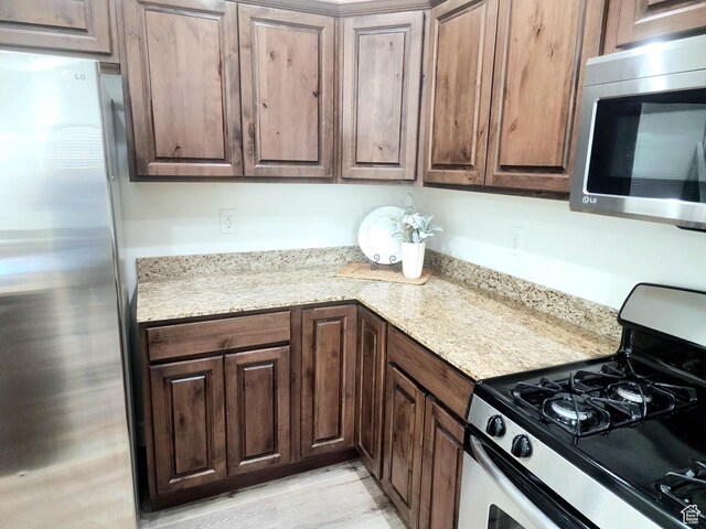246 E Topspin Way, Lehi, UT 84043 - kitchen featuring appliances with stainless steel finishes, dark brown cabinets, and light wood finished floors