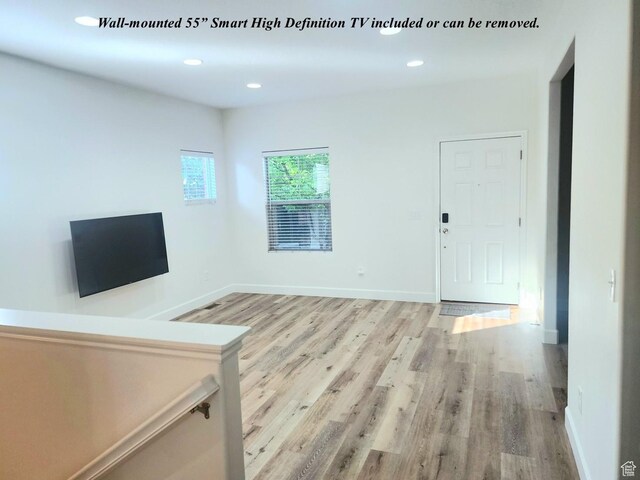 246 E Topspin Way, Lehi, UT 84043 - unfurnished living room with light wood finished floors, recessed lighting, and baseboards
