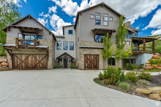 1685 N 300 E, Midway, UT 84049 - view of front facade featuring board and batten siding, stone siding, and a balcony