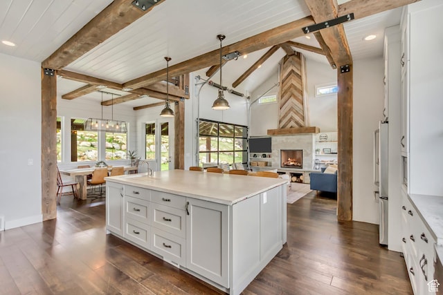 1685 N 300 E, Midway, UT 84049 - kitchen with plenty of natural light, beam ceiling, a large fireplace, a center island with sink, and recessed lighting