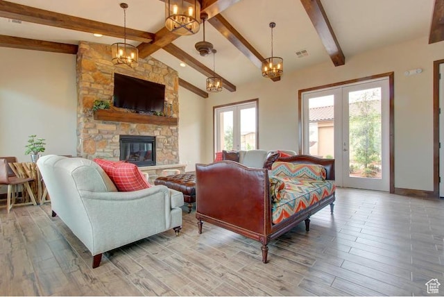 3800 Paradise Village Dr Unit 84, Santa Clara, UT 84765 - living room featuring light wood-style flooring, a fireplace, a chandelier, and french doors