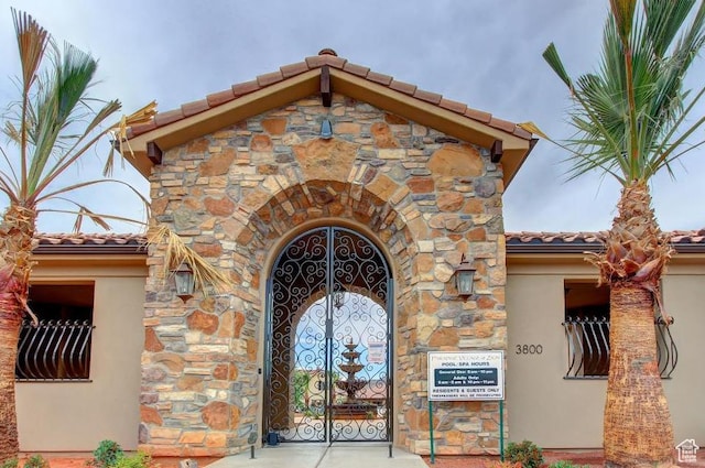 3800 Paradise Village Dr Unit 84, Santa Clara, UT 84765 - doorway to property with a tile roof, stone siding, and stucco siding