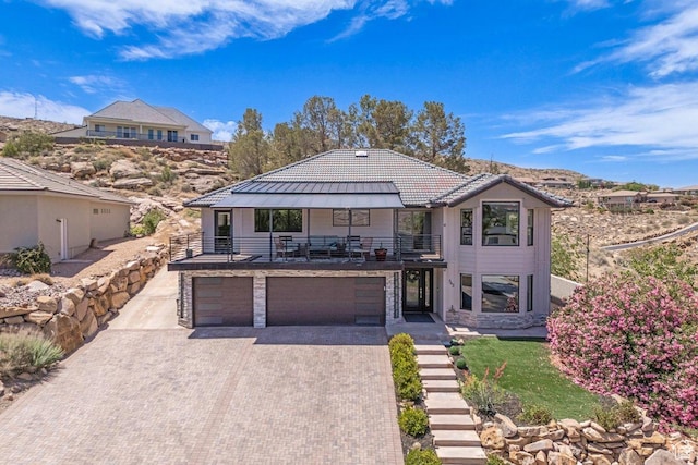 342 E Vermillion Ave, St George, UT 84790 - contemporary home with a balcony, a garage, a standing seam roof, decorative driveway, and metal roof